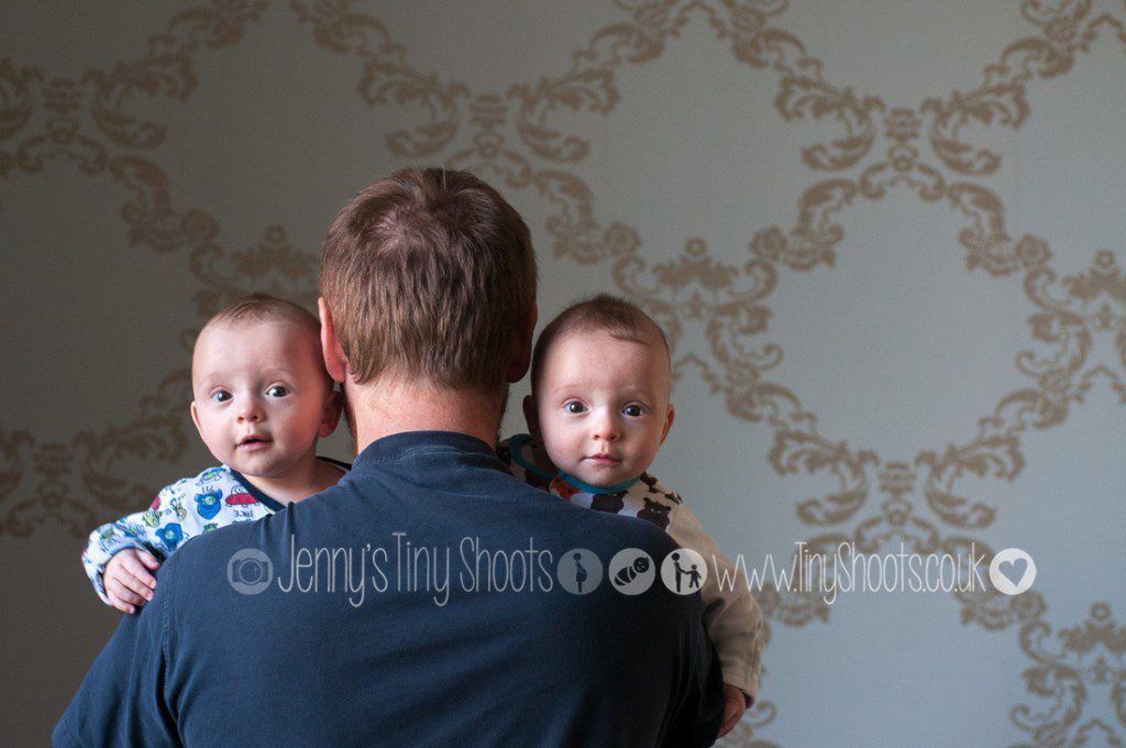 Daddy with twins looking over shoulder