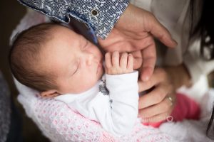 Holding hands with a newborn baby