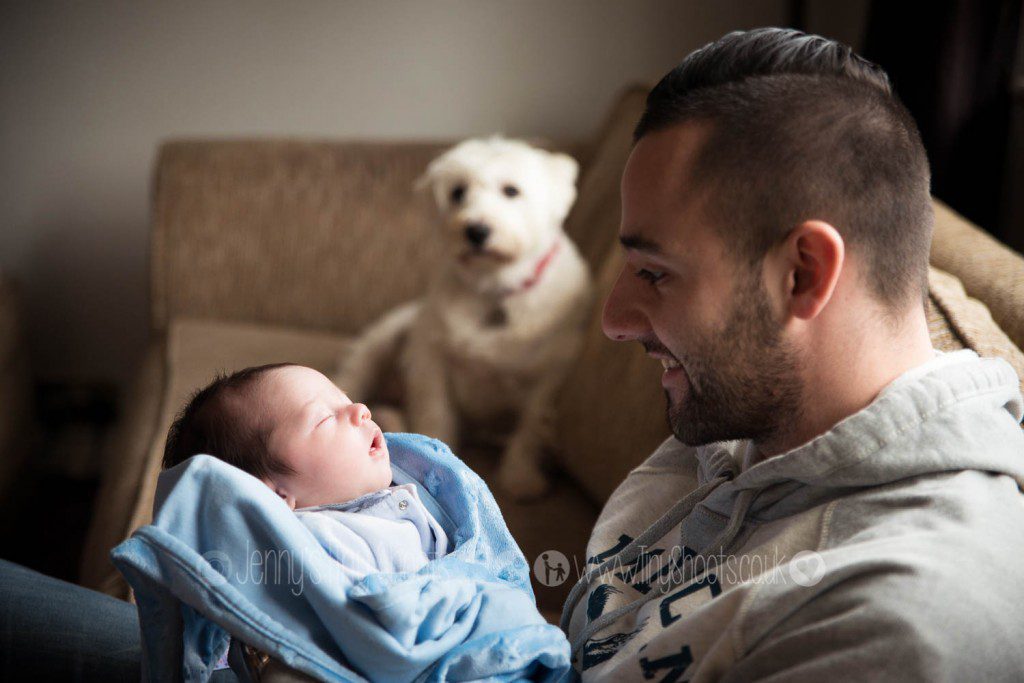 Newborn baby photographer Denham - at home with Dad and the family dog.
