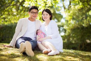 Family outdoors with their new baby