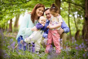 Baby and family in bluebells