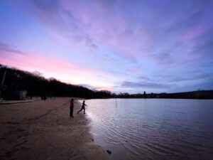 Boys by Ruislip Lido lake in the sunset