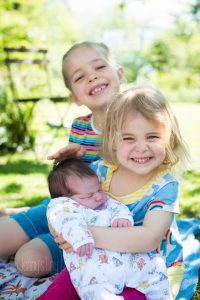 Newborn baby and siblings portrait