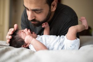 newborn being comforted by dad
