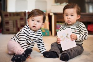 Twins with first birthday card