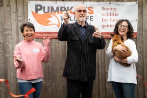 3 people cutting a ribbon at Pumpkins wildlife hospital