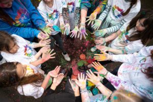 Childrens hands with coloured powder on them