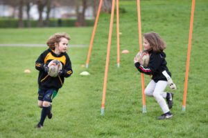 portrait of children playing rugby