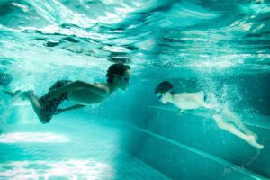portrait of children swimming underwater
