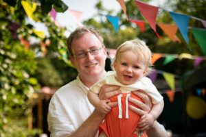 Baby boy and dad at a family celebration party
