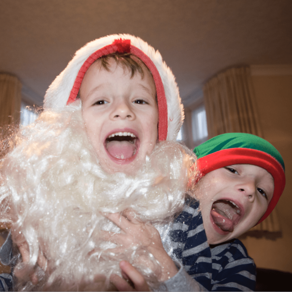 Boy dressed as santa with big grin