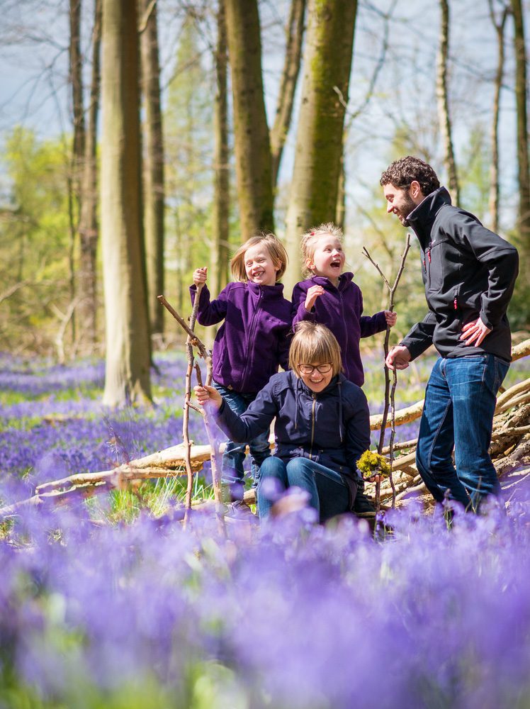 Lively family in bluebell woods