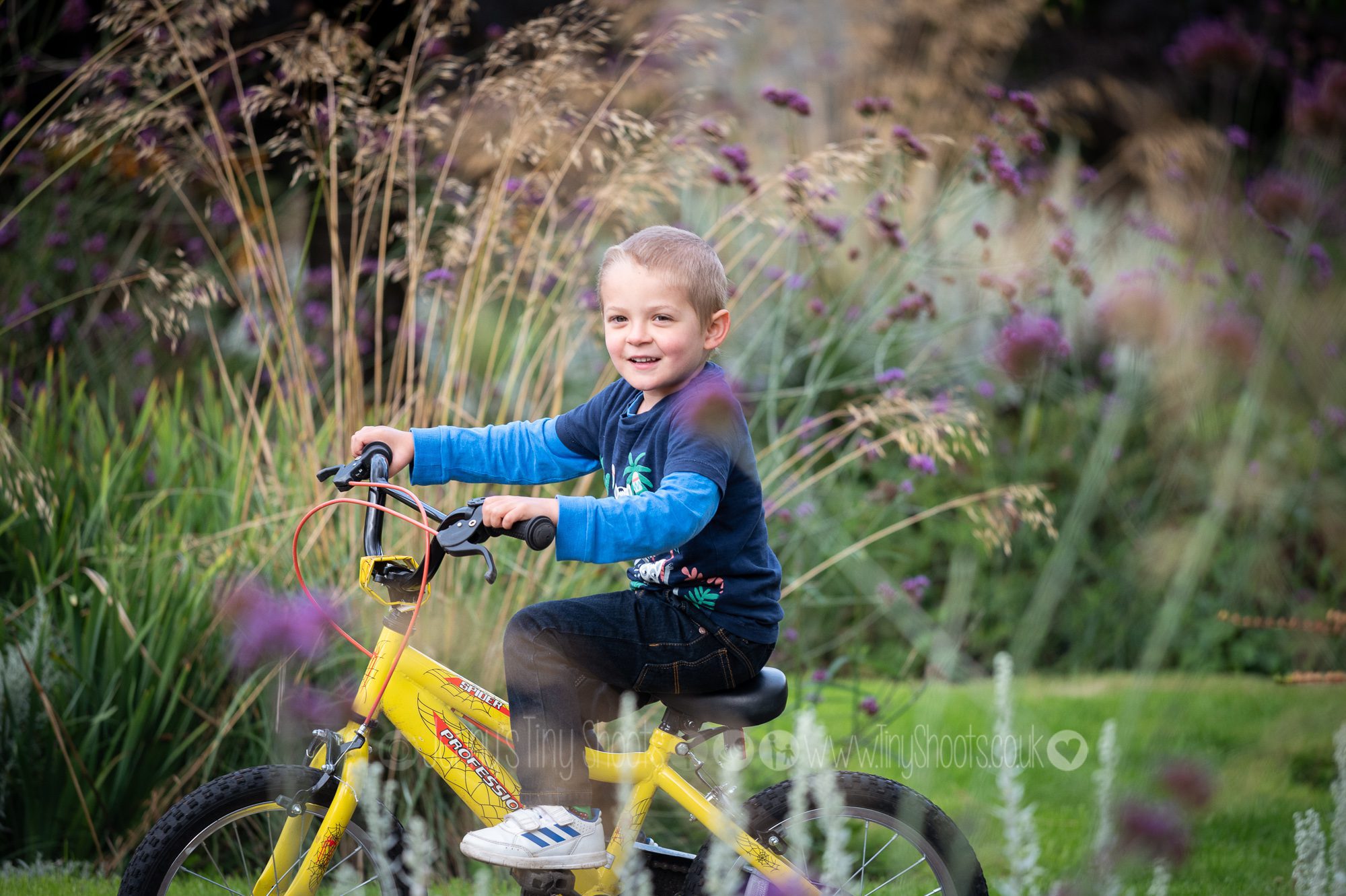Boy on a bike in garden