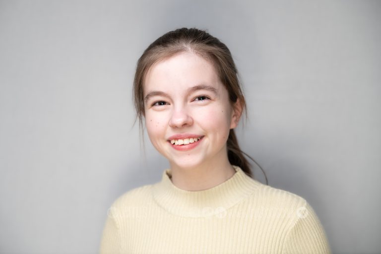 Young actress headshot with grey background