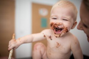1 year old boy covered in cake - cake smash at home