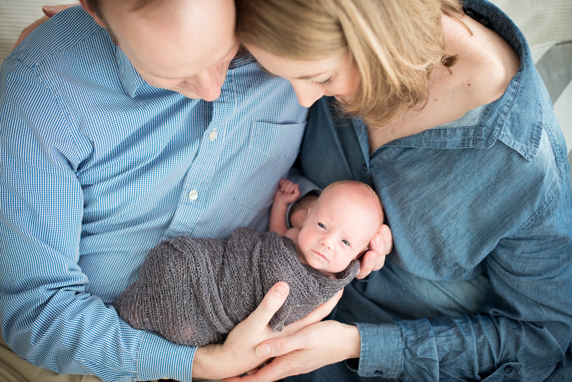 Cosy newborn portrait with family