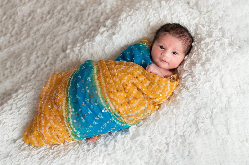 Baby girl newborn photo wrapped in sari
