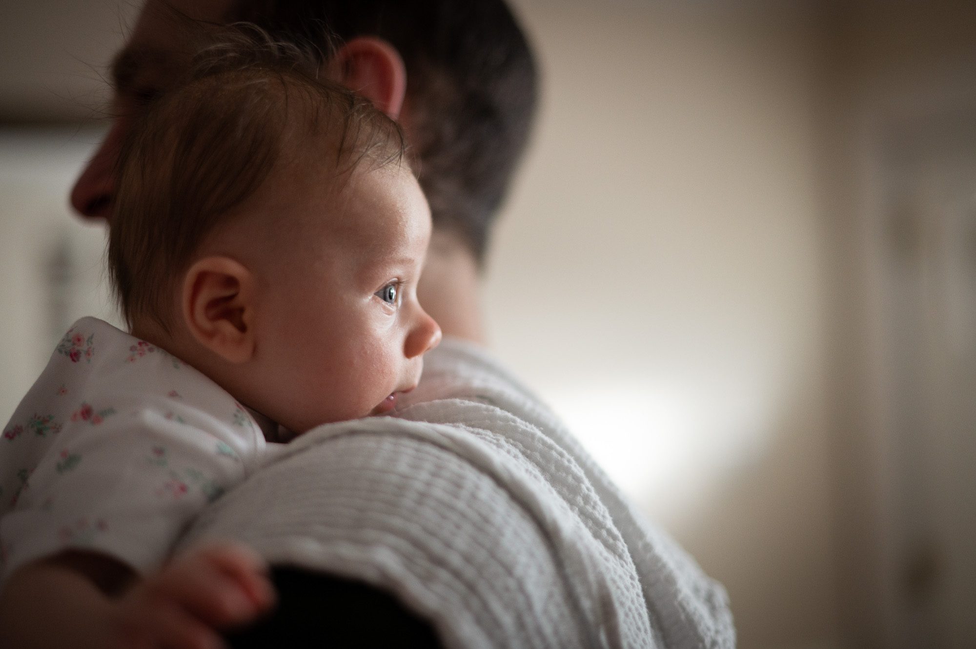 Baby looking over dad shoulder