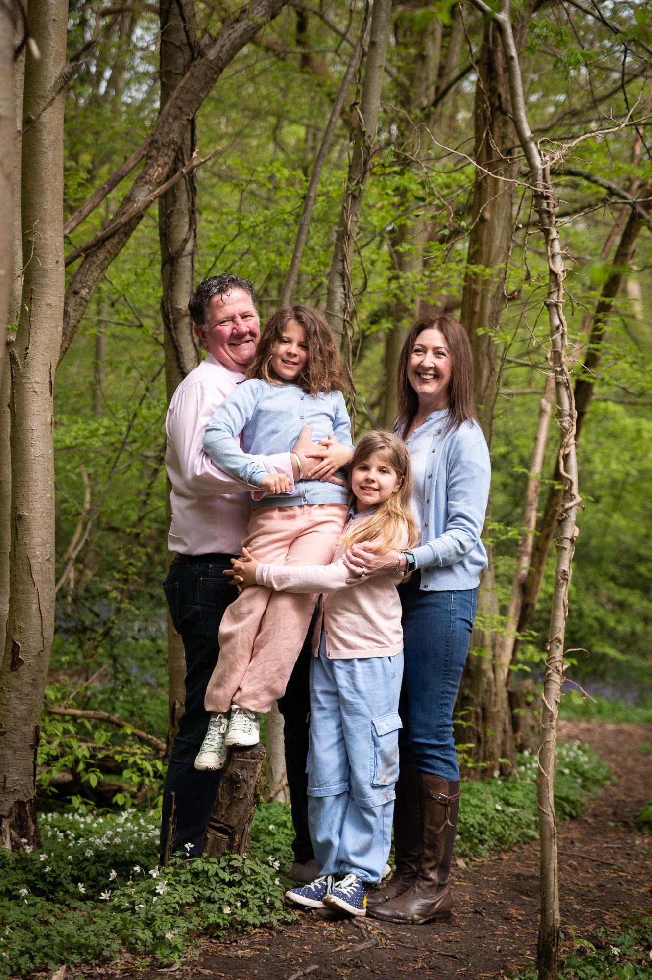 Outdoor family photoshoots in the woods - twin girls and a family cuddle.