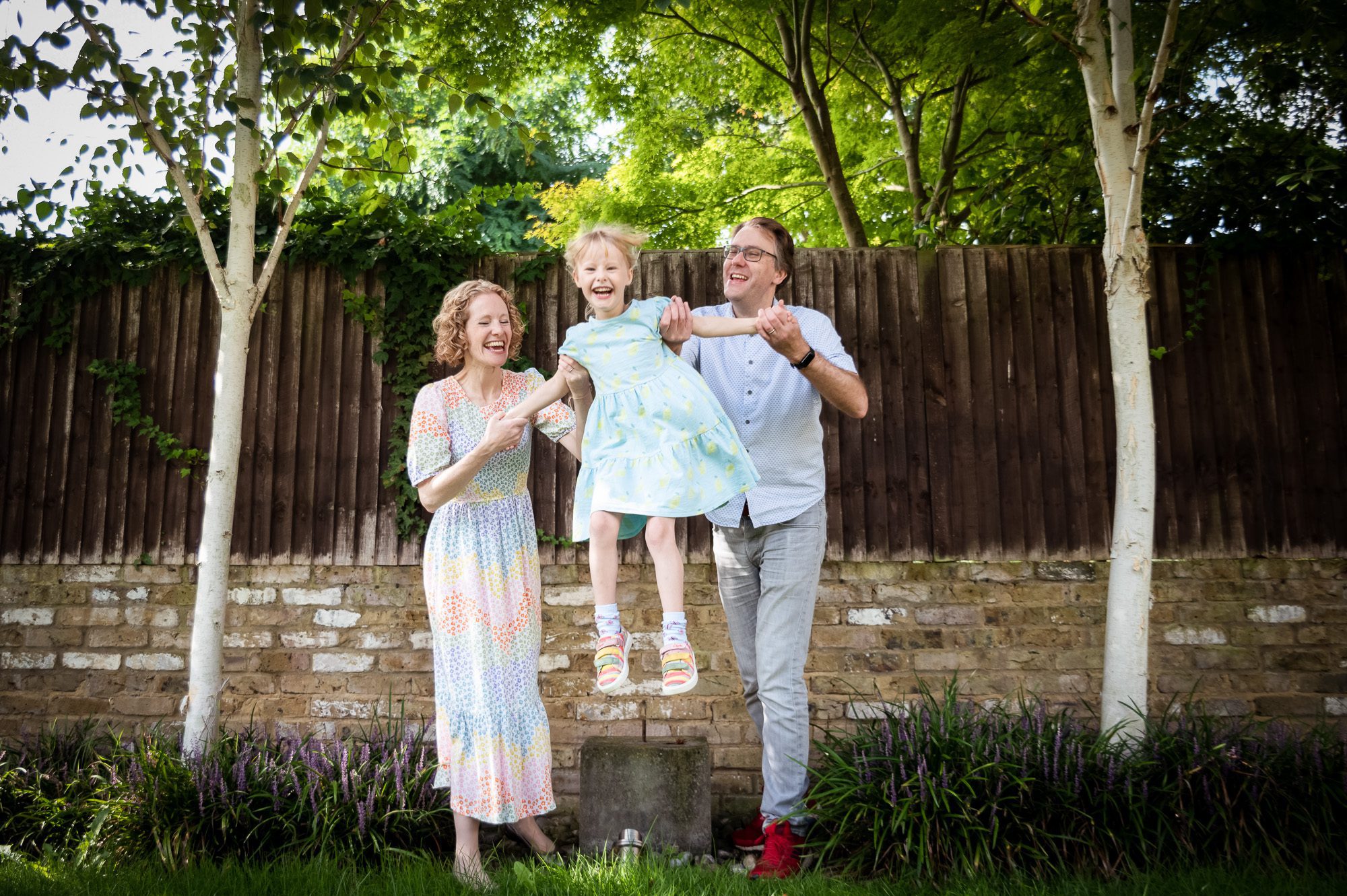 Girl jumping in garden - Outdoor family photoshoots at home