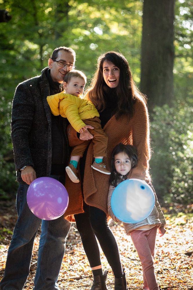 outdoor Family portrait in the autumn woods with balloon