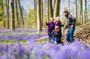 Family having fun at a spring photoshoot in the bluebells