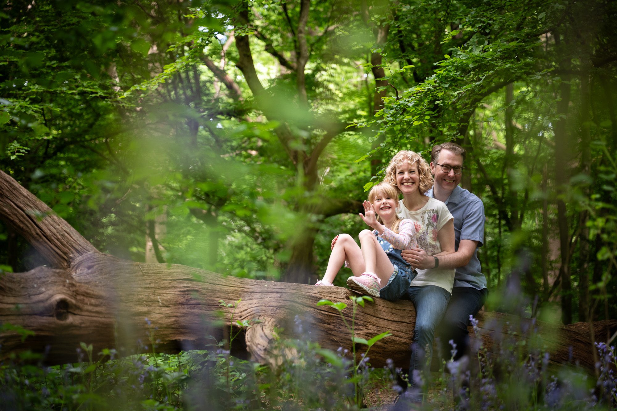 Family photo on an adventure in the woods with mum, dad, 8 year old daughter