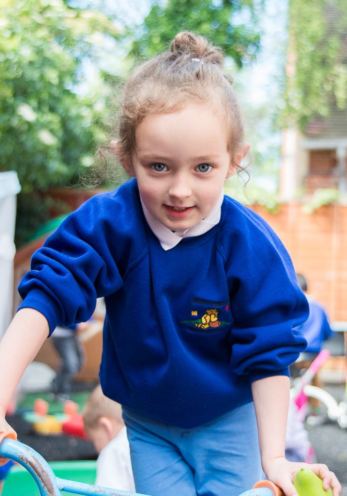 4 year old girl nursery portrait outdoors playing